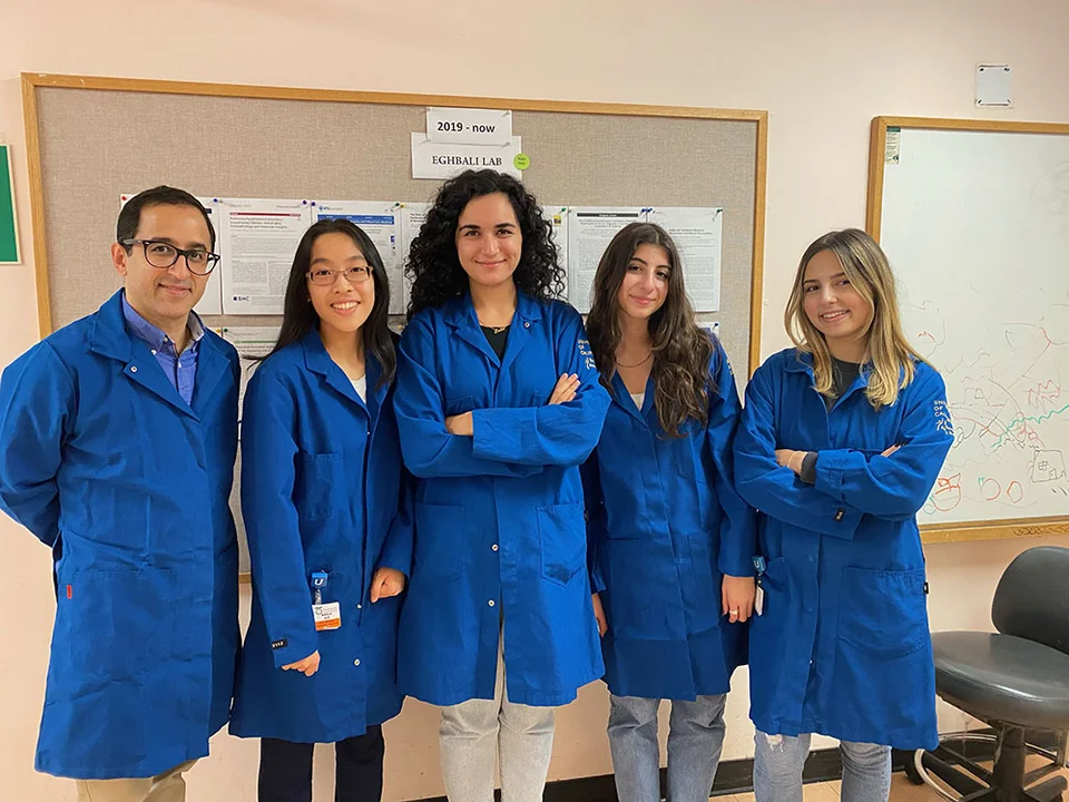 Group of four in blue lab coats