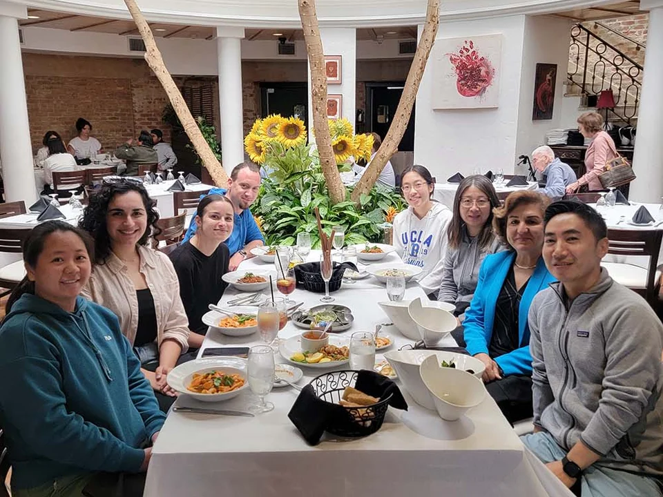 Group sitting at outdoor restaurant table  