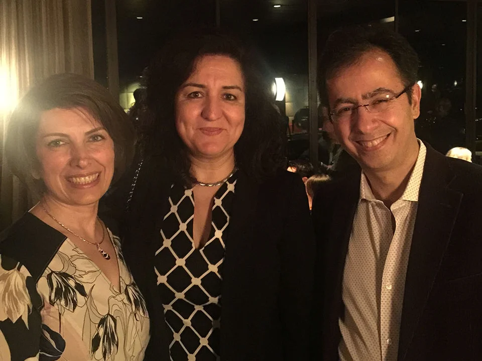 Group of three lab members smiling at an event.